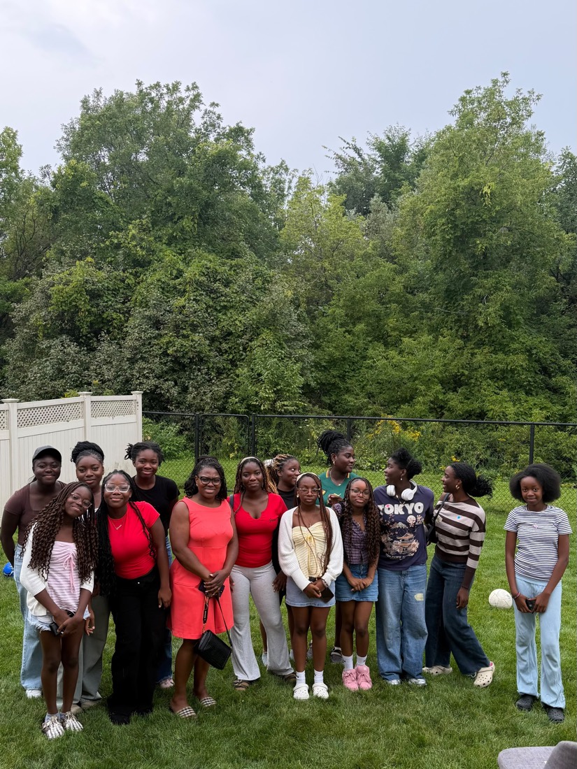Young women and mentors gathered for a group photo on the lawn during the peer support circle day