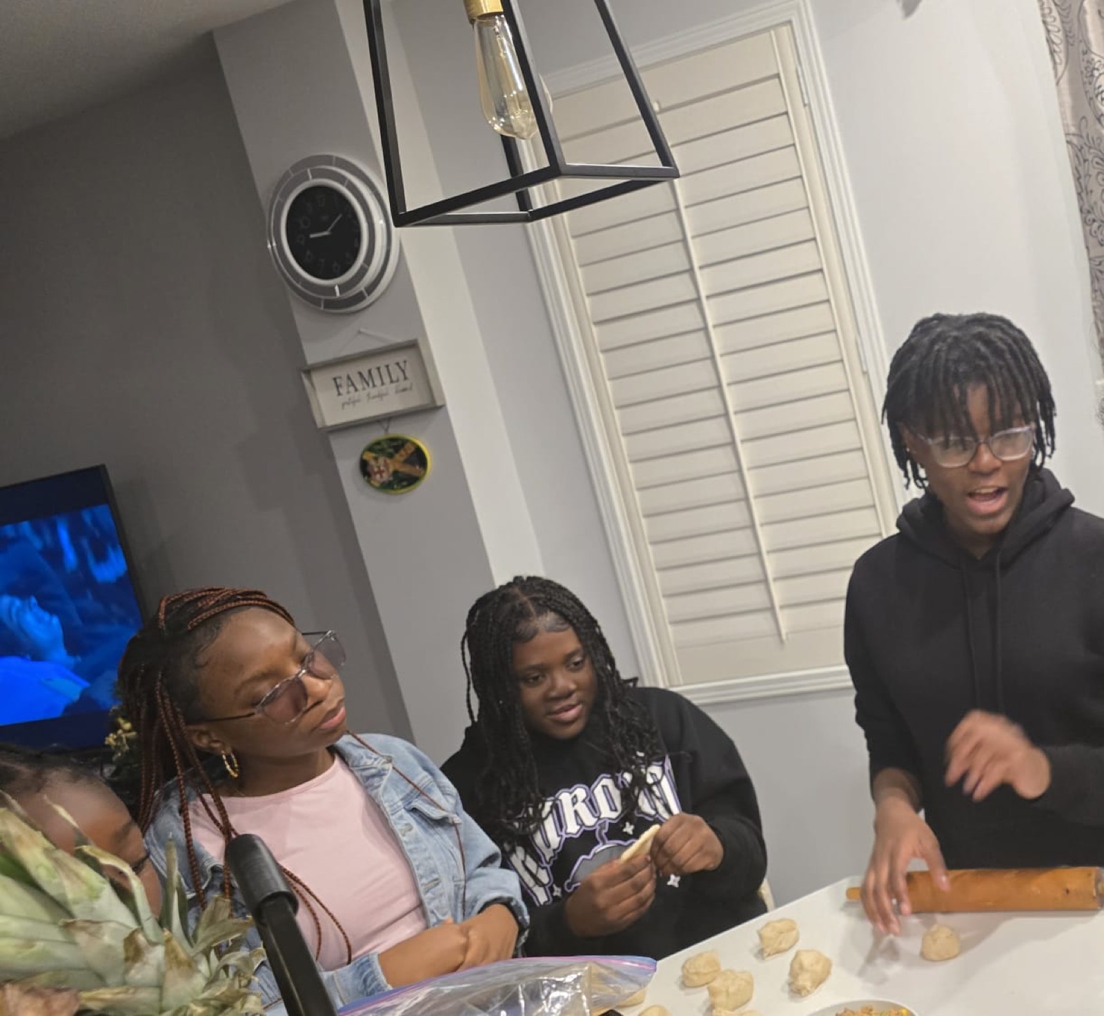 Youth learning to make dumplings and pastries with a mentor