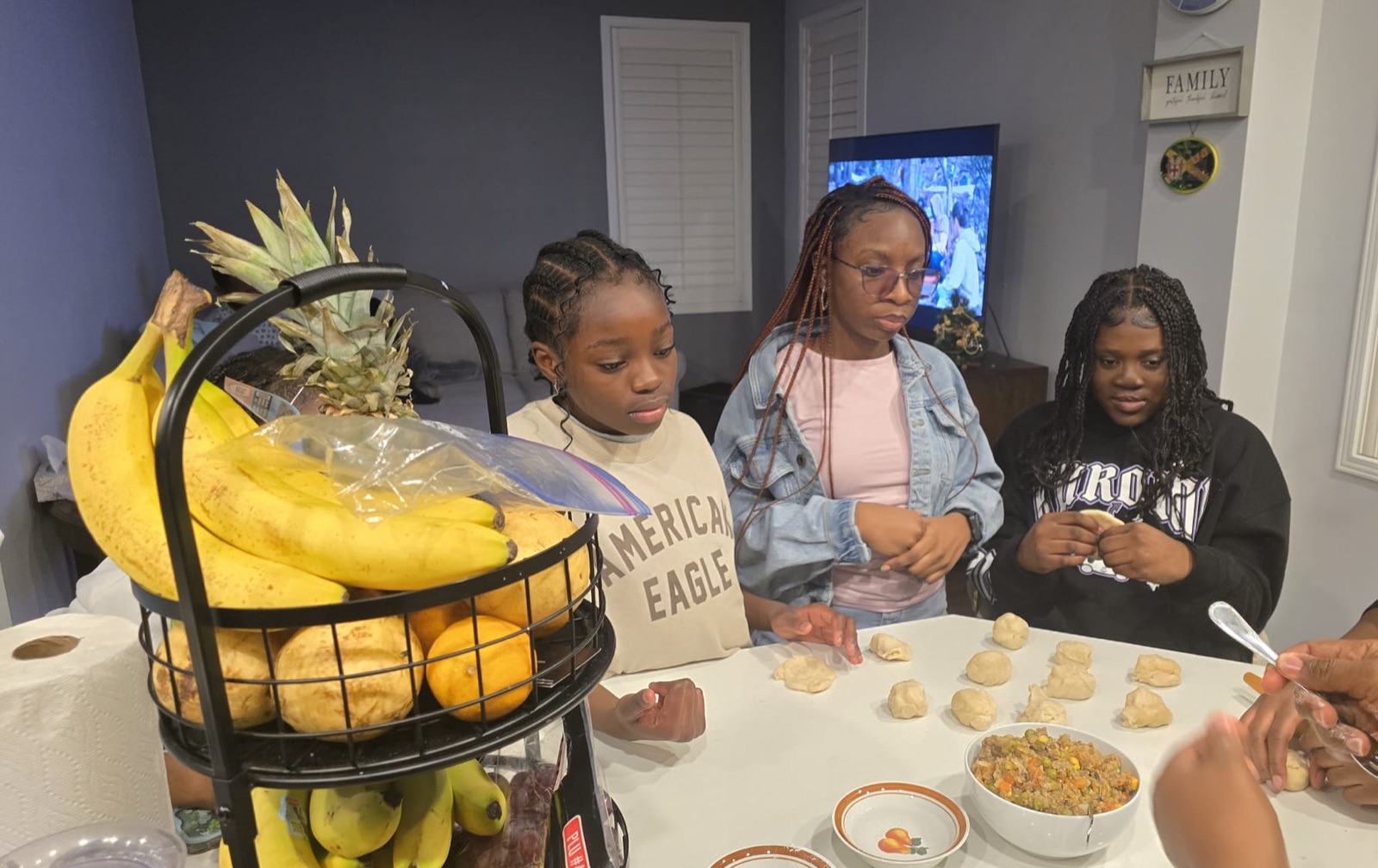 Youth and mentor in a hands-on culinary session shaping pastries