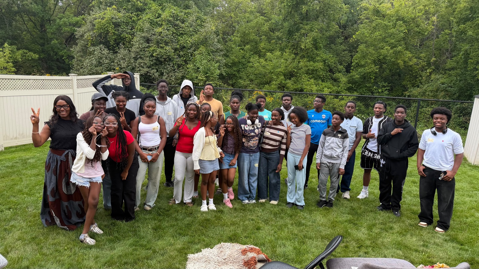 The full group of youth and mentors together outdoors at the summer peer support circle day